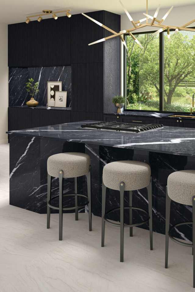 natural slate tile flooring in modern kitchen with black marble countertop and gold accent lighting